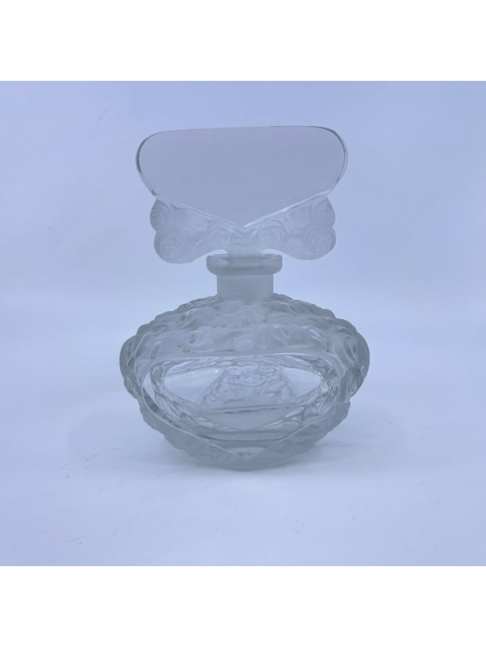 vintage pressed glass perfume bottle with floral design and stopper